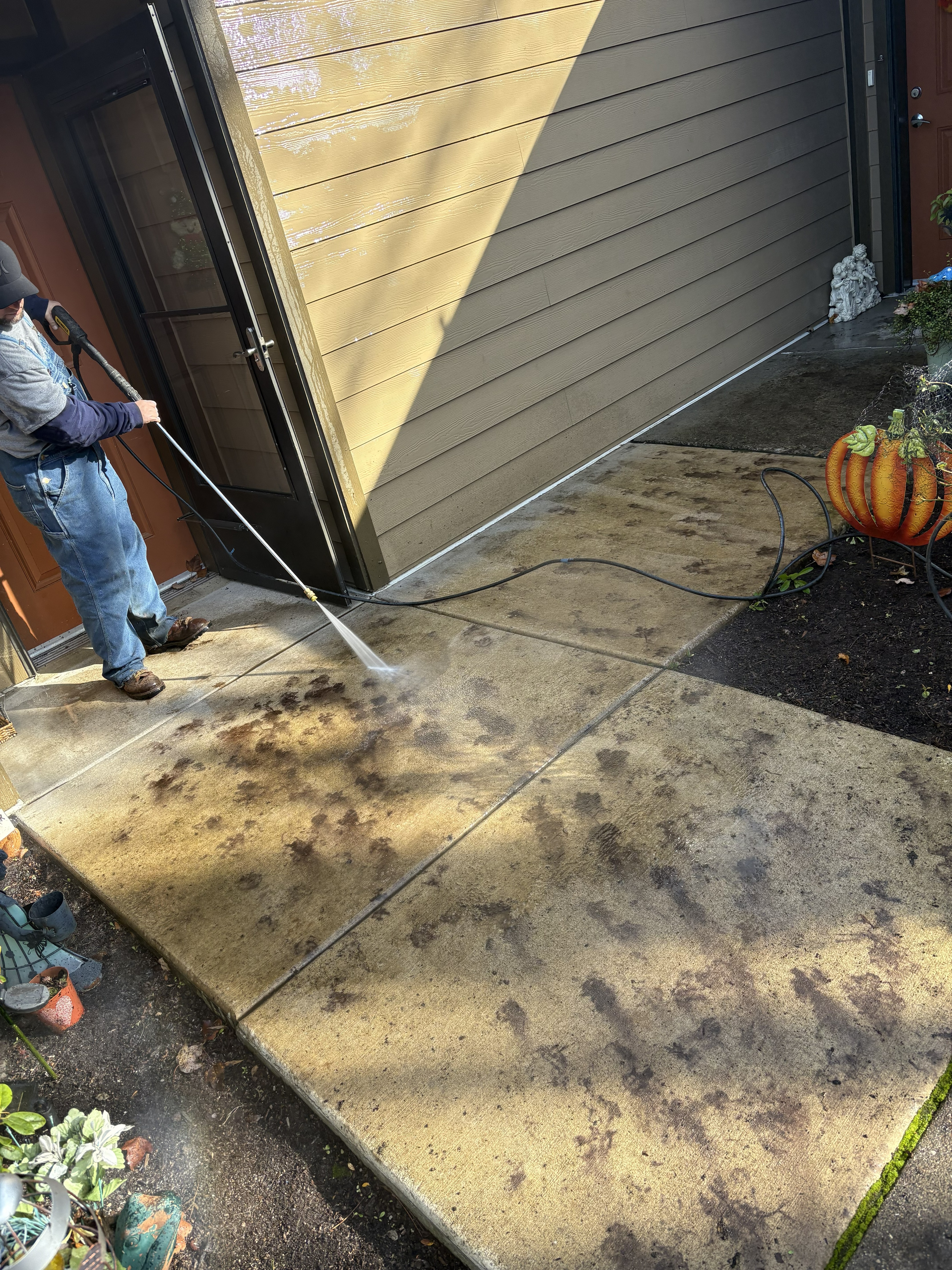 Pressure washing a concrete entry walkway